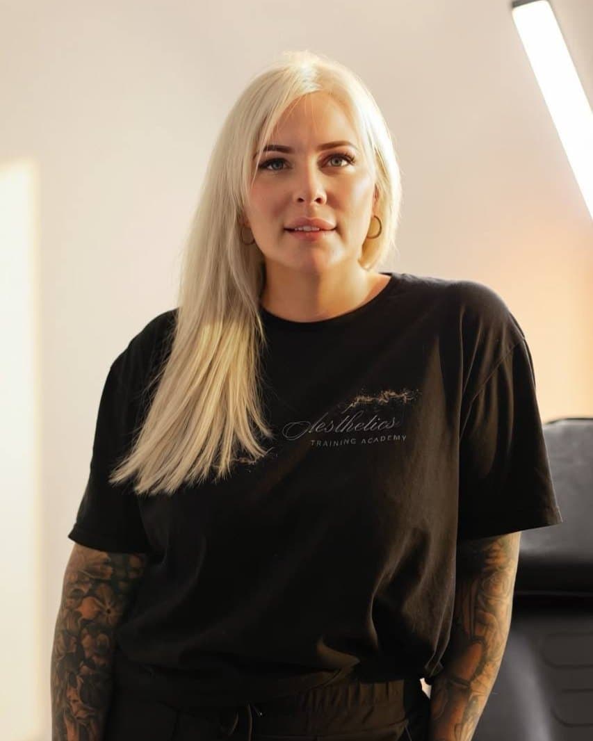 The owner of Empire Aesthetics, standing in a treatment room